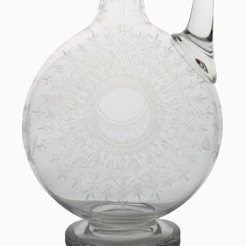 54 - A Victorian English glass claret jug, possibly by Thomas Webb, finely engraved with leaves and star ... 