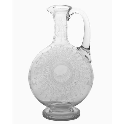 54 - A Victorian English glass claret jug, possibly by Thomas Webb, finely engraved with leaves and star ... 