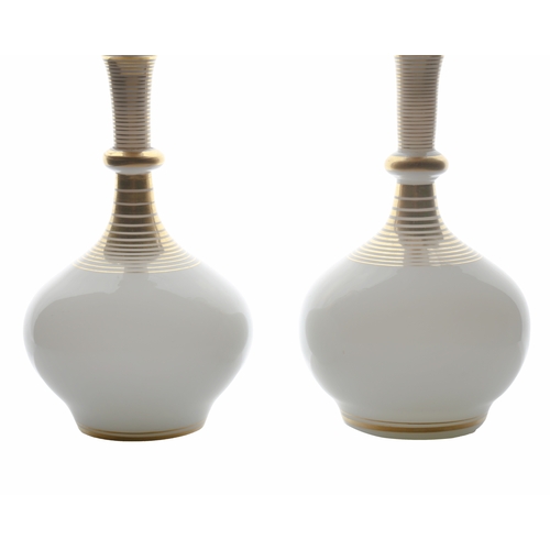 55 - A pair of French mid 19th Century white opaline perfume decanters, circa 1850, with gilded ring deco... 