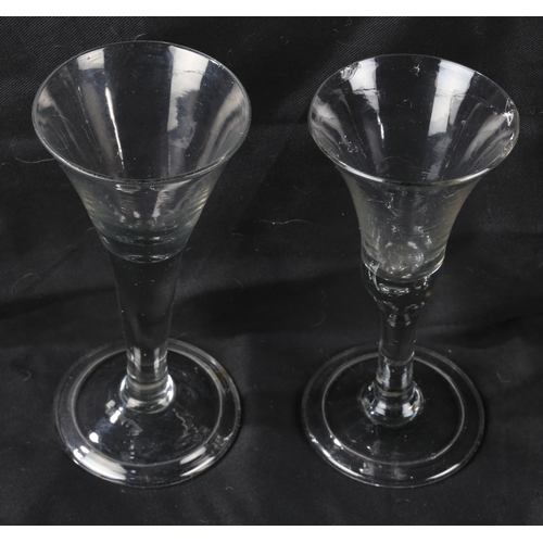 66 - An English plain stem trumpet wine goblet, c.1750 18.5cm high, together with a further example (2)