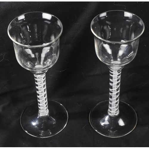 67 - A pair of Georgian wine glasses, c.1760 the ogee bowls over an opaque twist stem 21cm high (2)