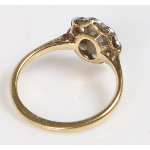 10 - A yellow metal, platinum and diamond ring, the head set with a central round diamond surrounded by a... 