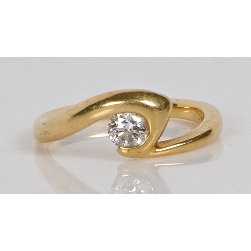 11 - An 18 carat gold and diamond solitaire ring, the crossover band set with a single round brilliant cu... 