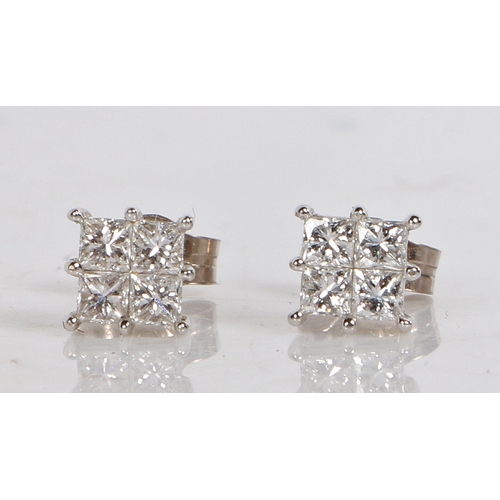 12 - A pair of 18 carat white gold and diamond set ear studs, of square form each set with four square cu... 