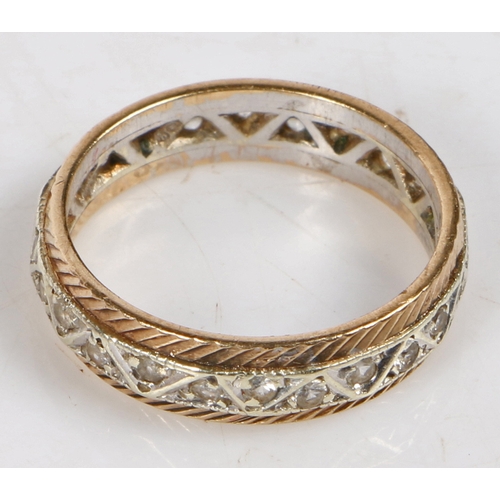 13 - A 9 carat gold and diamond full eternity ring, the central white gold band set with round cut diamon... 