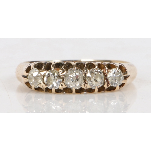 17 - An 18 carat gold ring set with five graduated diamonds, the central stone measuring 3.4mm diameter, ... 