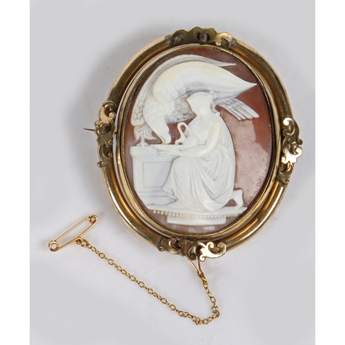 26 - A Victorian shell cameo brooch, the cameo depicting  Hebe and the eagle, housed in a swivel mount wi... 