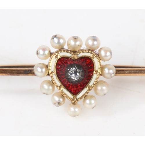 27 - A 15 carat gold bar brooch, the central red and white enamelled heart with diamond to the centre sur... 