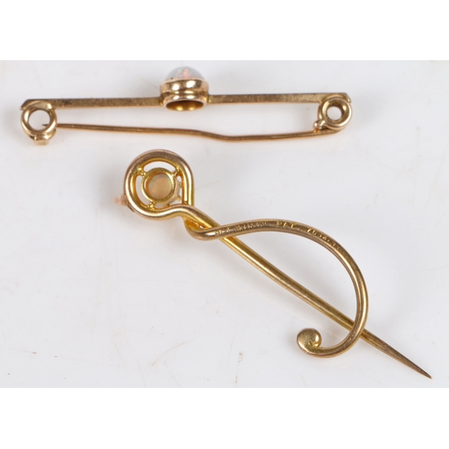 30 - A 15 carat gold bar brooch set with a central opal, 41.5mm wide, 1.9g, a 9 carat gold stick pin set ... 