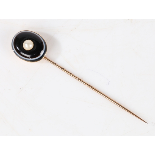 34 - A yellow metal, banded agate and pearl set stick pin, the head set with an oval banded agate centred... 