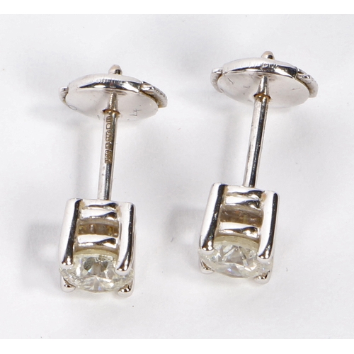 4 - A pair of 18 carat white gold and diamond ear studs, the stones measuring 5.6 and 5.5mm diameter, ho... 