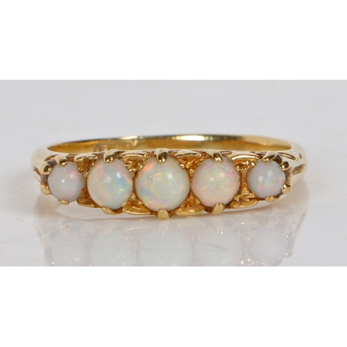 53 - An 18 carat gold and opal ring, the head set with five graduated circular opals, ring size Q, 3.7g