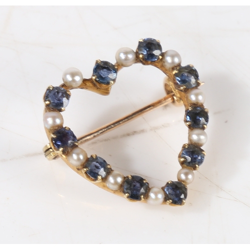 57 - A yellow metal, sapphire and pearl heart form brooch, the pierced heart form brooch bordered with al... 