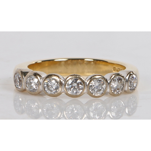 8 - An 18 carat gold and diamond ring, set with seven round brilliant cut diamonds, ring size K 1/2, 5.3... 