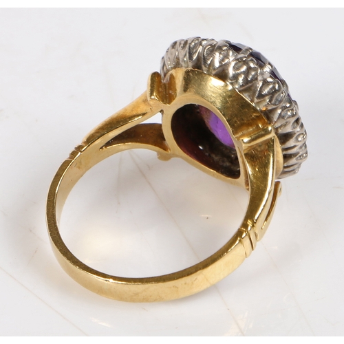 83 - An 18 carat gold amethyst and diamond ring, centred with an oval cut amethyst surrounded by diamonds... 