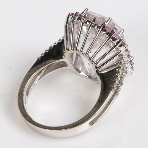 86 - An 18 carat gold kunzite and pink sapphire ring, the central facet cut kunzite surrounded by a band ... 