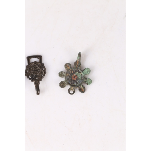 10 - ARTIFACTS. To include a Roman brooch with central red enamel present, an Elizabethan clothes fastene... 