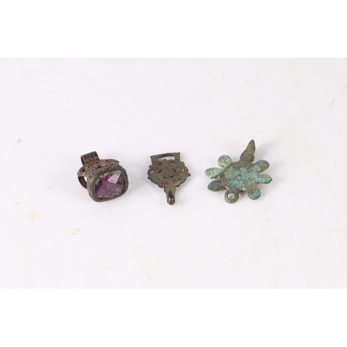 10 - ARTIFACTS. To include a Roman brooch with central red enamel present, an Elizabethan clothes fastene... 