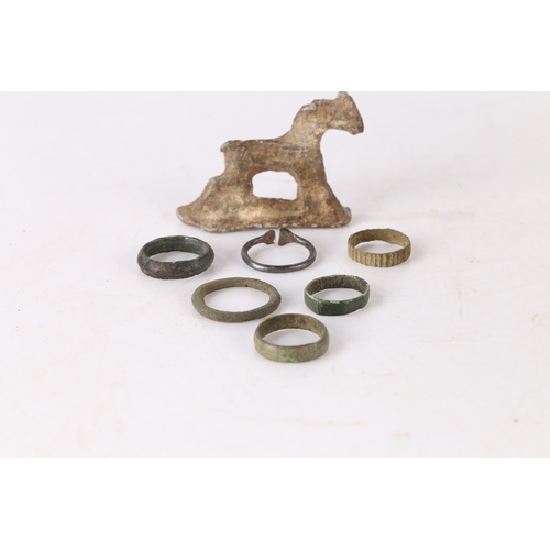 11 - ARTIFACTS. To include six Roman and later rings, also with a lead toy horse, (7)
Found Suffolk.