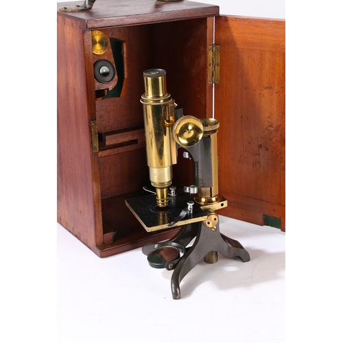 129 - A 19TH CENTURY MICROSCOPE BY BAKER. A 19th century Microscope by Baker, brass and black lacquered ho... 