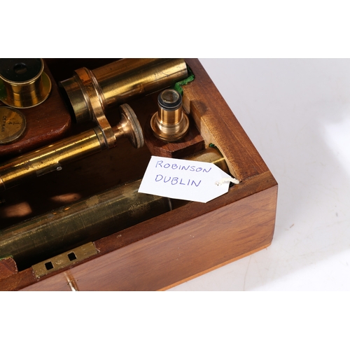 135 - A ROBINSON OF DUBLIN MICROSCOPE. A Robinson of Dublin microscope, brass housed within a fitted case ... 