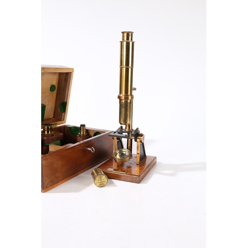 135 - A ROBINSON OF DUBLIN MICROSCOPE. A Robinson of Dublin microscope, brass housed within a fitted case ... 