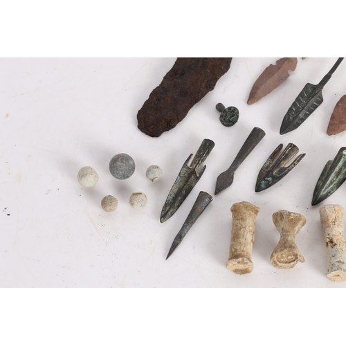 14 - A COLLECTION OF ARTIFACTS. To include bronze Roman arrow heads, (some not period) a phallic pendant,... 