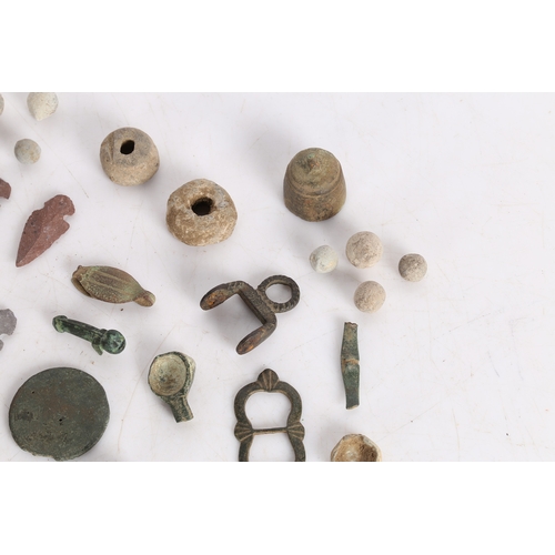 14 - A COLLECTION OF ARTIFACTS. To include bronze Roman arrow heads, (some not period) a phallic pendant,... 