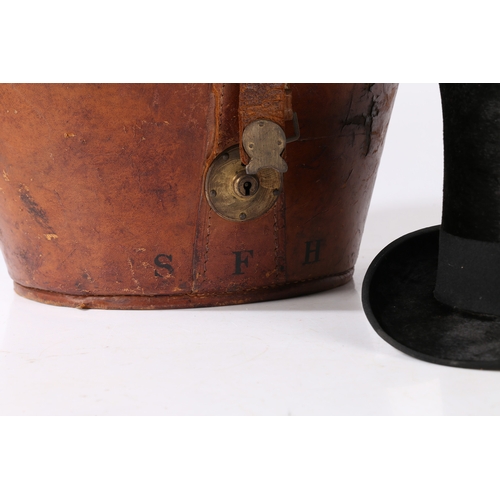 143 - A VICTORIAN MOLESKIN TOP HAT WITH A LEATHER FITTED CASE. A Victorian moleskin top hat with a leather... 