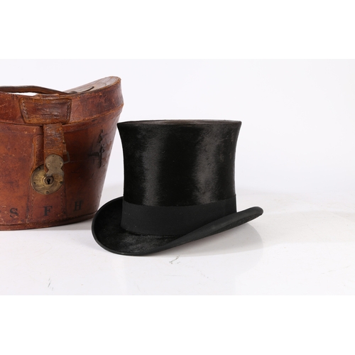 143 - A VICTORIAN MOLESKIN TOP HAT WITH A LEATHER FITTED CASE. A Victorian moleskin top hat with a leather... 