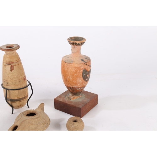 16 - A COLLECTION OF ARTIFACTS. To include two Greek vases 11cm high and 12cm high, a Roman period oil la... 