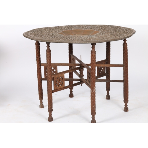 165 - AN INDIAN BENARES TABLE. An Indian Benares table, having a brass embossed top with a floral vine dec... 