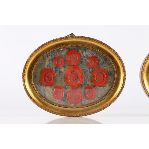 169 - A PAIR OF FRAMED WAX SEALS, THE ARRAIGNMENTS WITH FIGURAL AND CLASSICAL RED SEALS. Pair of framed wa... 