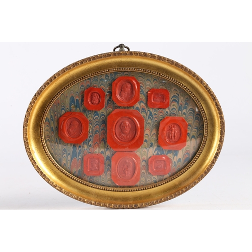 169 - A PAIR OF FRAMED WAX SEALS, THE ARRAIGNMENTS WITH FIGURAL AND CLASSICAL RED SEALS. Pair of framed wa... 