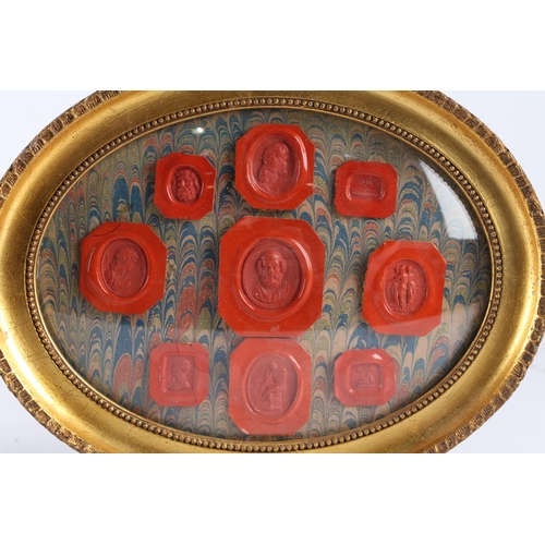 169 - A PAIR OF FRAMED WAX SEALS, THE ARRAIGNMENTS WITH FIGURAL AND CLASSICAL RED SEALS. Pair of framed wa... 