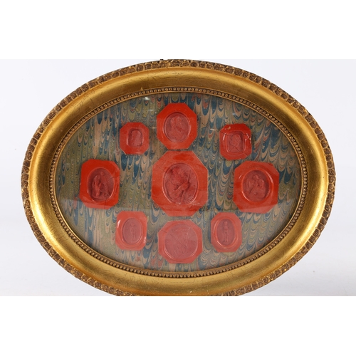 169 - A PAIR OF FRAMED WAX SEALS, THE ARRAIGNMENTS WITH FIGURAL AND CLASSICAL RED SEALS. Pair of framed wa... 