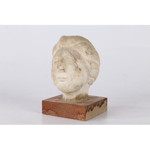 17 - A CARVED MARBLE BUST, PROBABLY ROMAN. A carved marble bust of a female head with bunched hair, 10cm ... 