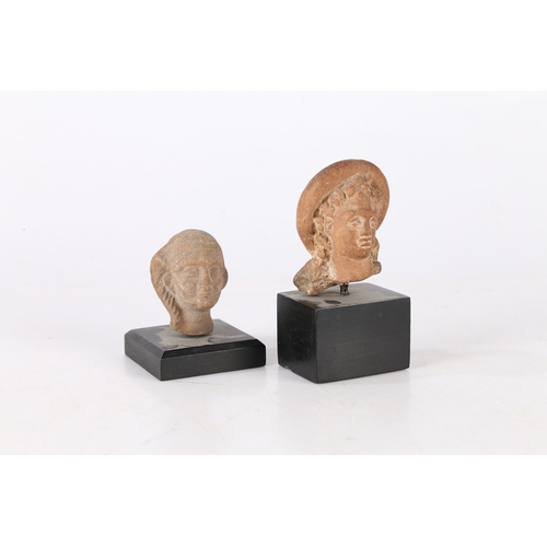 18 - TWO ANCIENT ETRUSCAN TERRACOTTA BUSTS, CIRCA 3RD-2ND CENTURY B.C (2). The first a female head raised... 