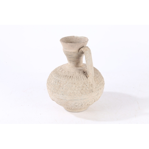 31 - AN EARLY ISLAMIC UNGLAZED POTTERY EWER, PERSIA OR SYRIA, 12TH/ 13TH CENTURY. Decorated with palmette... 