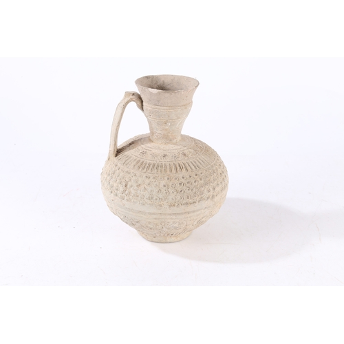 31 - AN EARLY ISLAMIC UNGLAZED POTTERY EWER, PERSIA OR SYRIA, 12TH/ 13TH CENTURY. Decorated with palmette... 