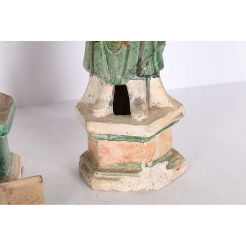 33 - TWO CHINESE POTTERY TOMB ATTENDANTS. Probably Tang Dynasty, both standing, one with hands raised and... 