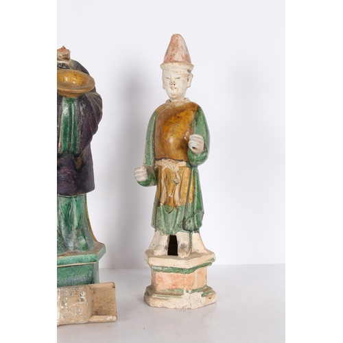 33 - TWO CHINESE POTTERY TOMB ATTENDANTS. Probably Tang Dynasty, both standing, one with hands raised and... 