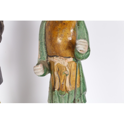 33 - TWO CHINESE POTTERY TOMB ATTENDANTS. Probably Tang Dynasty, both standing, one with hands raised and... 