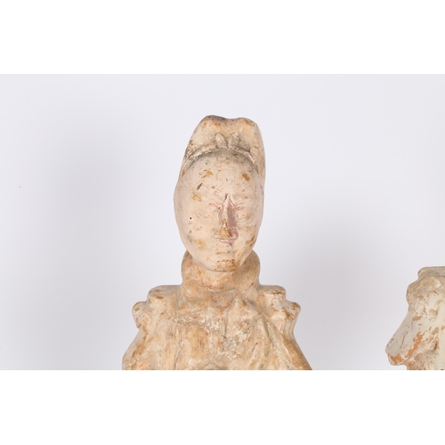 34 - TWO CHINESE TERRACOTTA ATTENDANTS. Both standing with arms to the chest, 44cm high, (2).