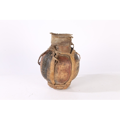 42 - AN AFRICAN WOODEN AND LEATHER WATER VESSEL. An African wooden and leather water vessel, early 20th c... 