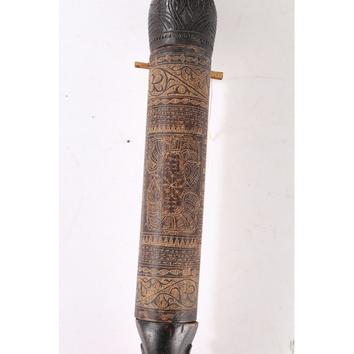 43 - AN AFRICAN CARVED CALENDAR. An African carved calendar of cylindrical form, 20th century, having a f... 