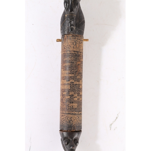 43 - AN AFRICAN CARVED CALENDAR. An African carved calendar of cylindrical form, 20th century, having a f... 