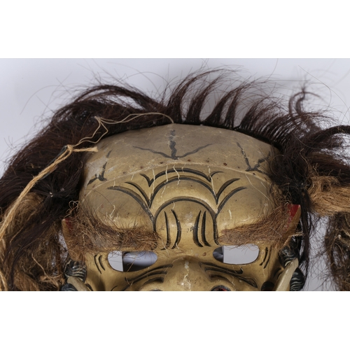 46 - A BALINESE CEREMONIAL GROTESQUE FACE MASK. A Balinese ceremonial grotesque face mask, having a paint... 