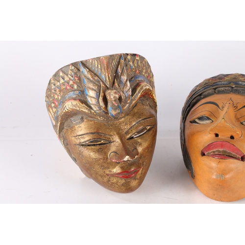 47 - THREE HAND PAINTED MASKS. Three hand painted masks, possibly Balinese, one having a gilt painted fac... 