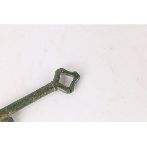 5 - AN ENGLISH MEDIEVAL KEY. With loop bow and two bits, 9cm long. 
Found in Suffolk.